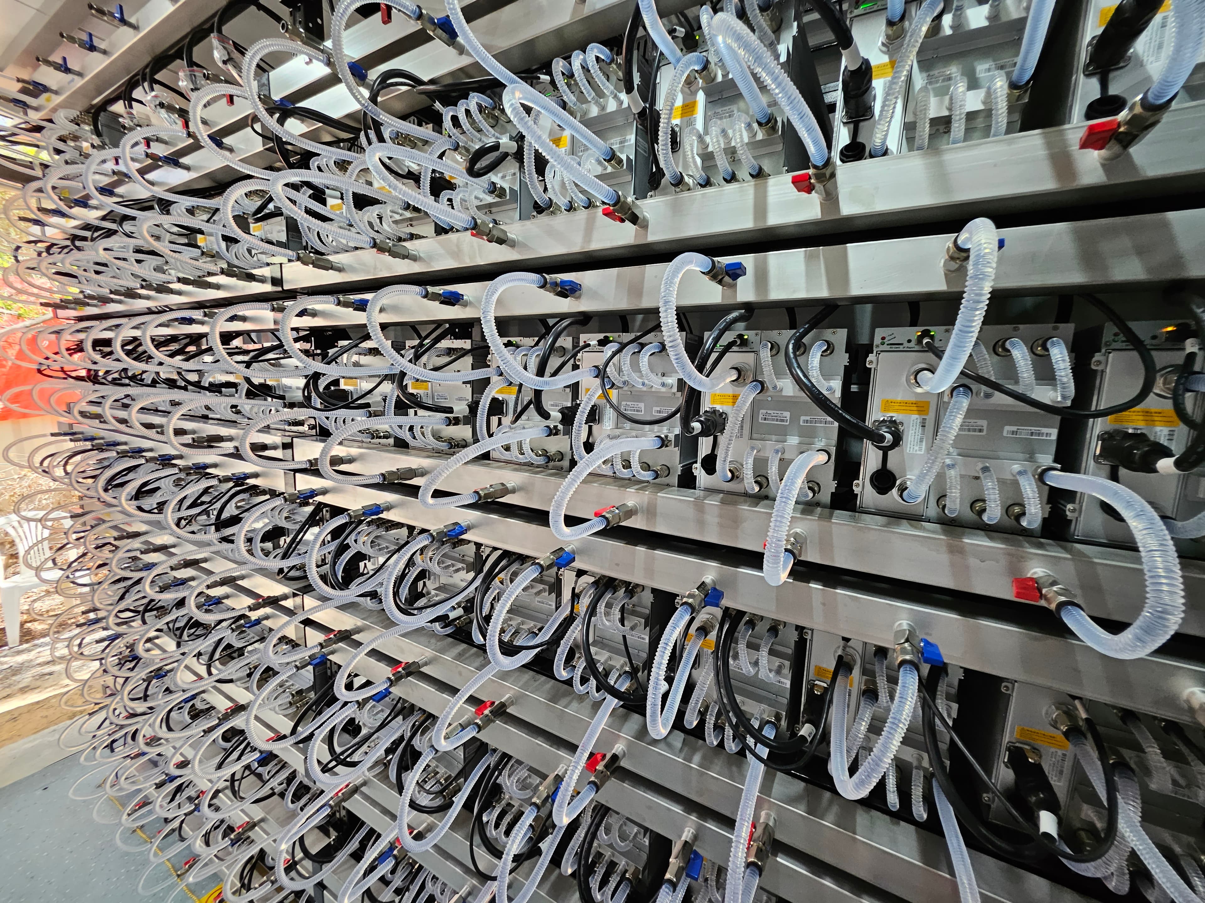 Immersion-cooled miners in high-density rack