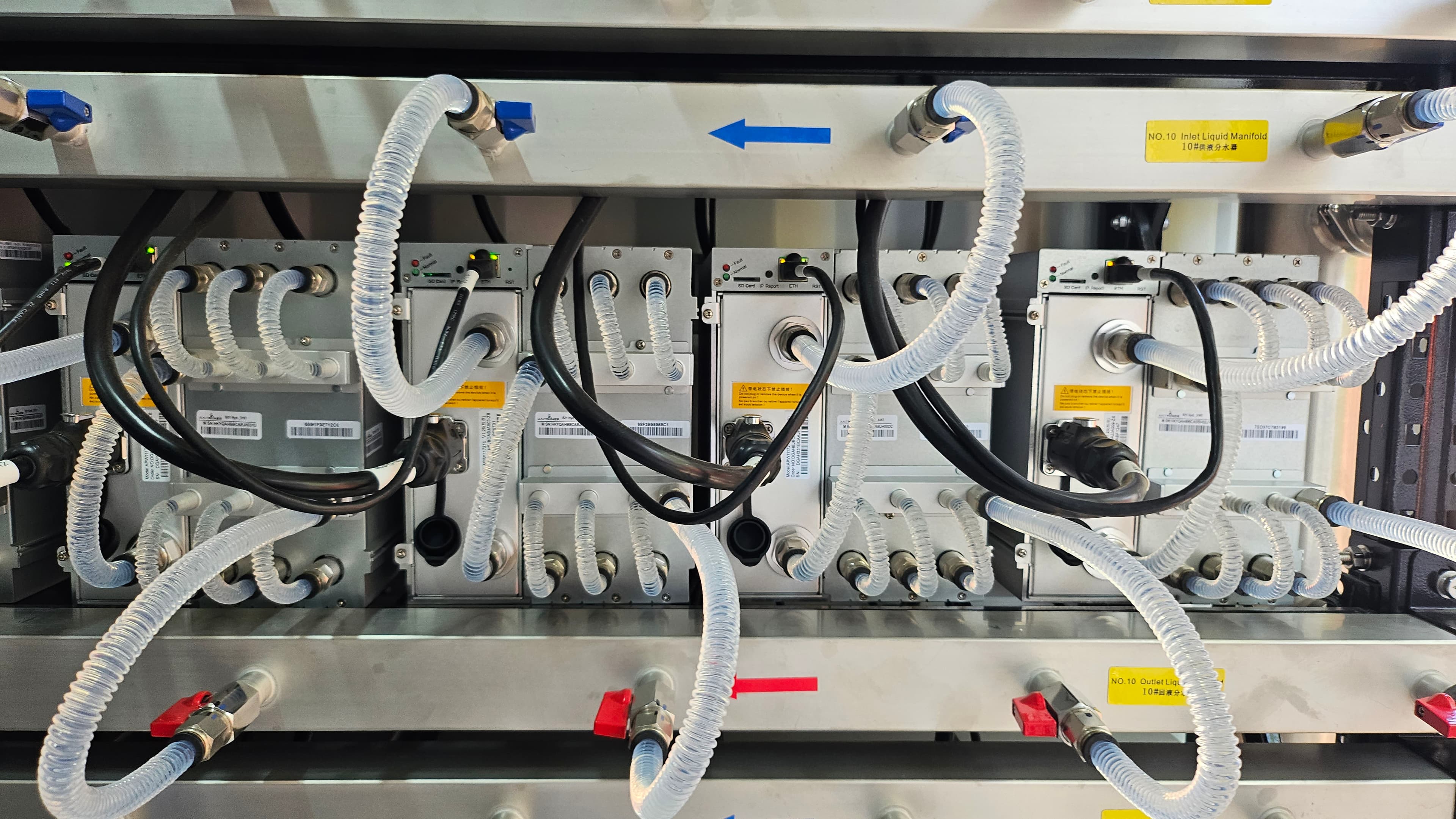 ASIC mining racks with liquid cooling manifolds